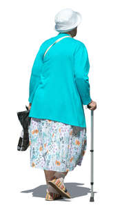 older woman with a walking stick walking