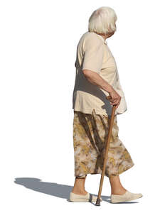 elderly woman with a walking stick walking on a summer day
