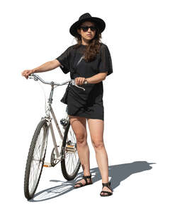 cut out woman in a black dress and black hat standing with a bicycle
