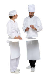 two cut out chefs talking behind a kitchen counter