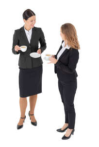 two cut out businesswomen drinking coffee seen from above