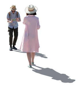 cut out backlit man taking a picture of a woman in a pink dress