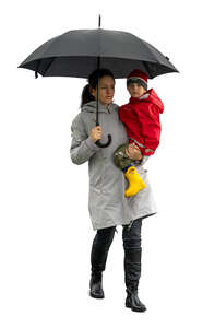 cut out woman and little boy walking in the rain with umbrella