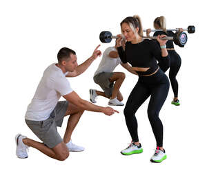 cut out personal trainer instructing a woman in gym