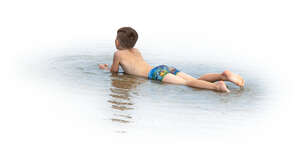 cut out boy lying in the water on the beach