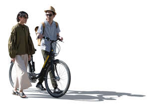 cut out backlit man and woman with a bike walking