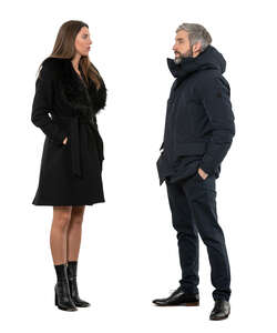 two cut out people in winter coats standing and talking