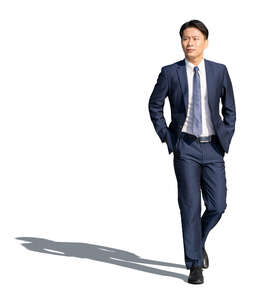 cut out asian man in a dark suit walking