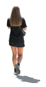 cut out backlit woman in a black mini dress walking