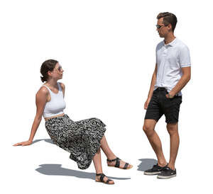 cut out woman sitting and talking to a man standing beside her