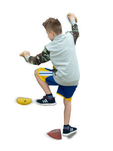 cut out boy climbing on a rock climbing wall