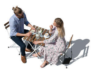 cut out top view of a man and woman sitting in an outdoor restaurant