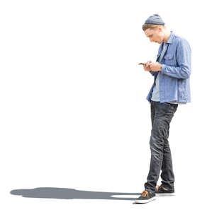 cut out sidelit young man with a phone standing 