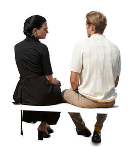 cut out man and woman sitting seen from back angle