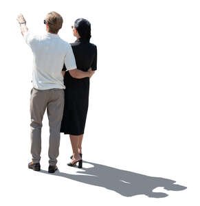 cut out backlit couple standing and pointing