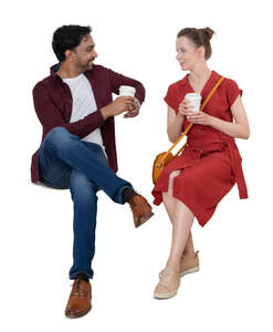two cut out people sitting on a bench and drinking coffee