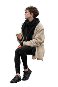 cut out woman sitting outside and drinking coffee from a disposable cup