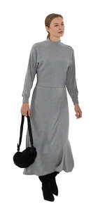 cut out woman in a long grey dress walking