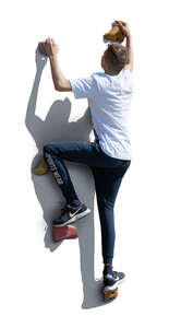 cut out boy climbing on an outdoor climbing wall