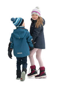two cut out kids walking hand in hand in winter