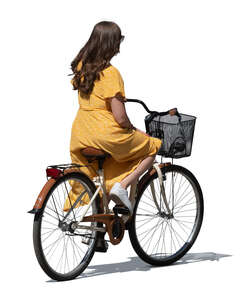 cut out young woman in a yellow dress riding a bike