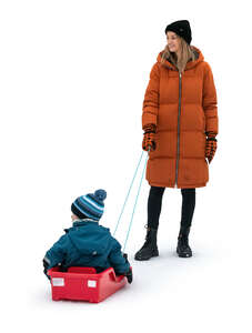 cut out woman standing with her son sitting on a sledge