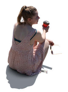 cut out backlit woman sitting and drinking coffee