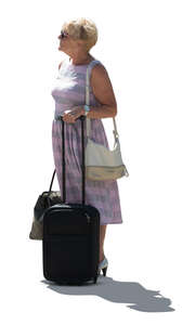 cut out older backlit woman with a suitcase standing