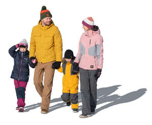 cut out family with two kids walking hand in hand on a sunny winter day