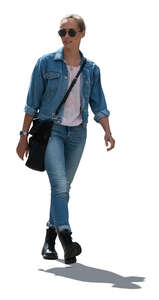 cut out backlit woman in denim outfit walking