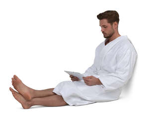 cut out man in a bathrobe sitting and looking at a tablet