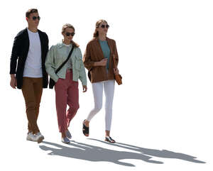 cut out backlit group of three people walking