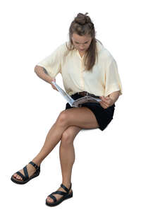 cut out top view of a woman sitting and reading