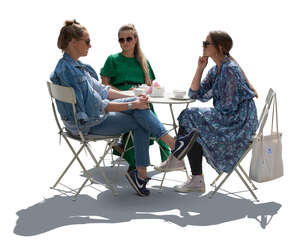 cut out group of backlit women sitting in a street cafe