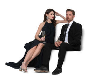 cut out man and woman sitting on a sofa and drinking champagne
