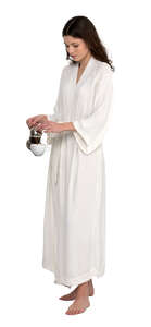 cut out woman in a light white bahthrobe preparing coffee