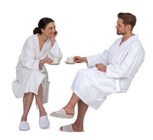 cut out couple in white bathrobes sitting and drinking coffee
