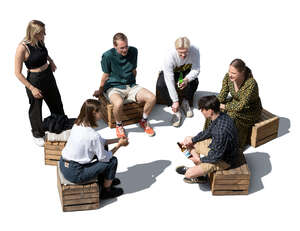 cut out group of young people sitting and talking seen from above