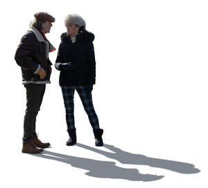cut out backlit elderly man and woman in winter standing and talking