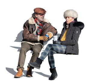 cut out elderly couple sitting and drinking coffee outside on a sunny winter day
