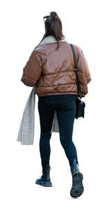 cut out woman in a brown puffer jacket walking