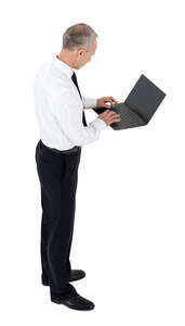 cut out businessman standing and working with laptop