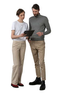 two cut out people standing and reading some papers