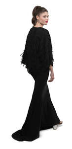 cut out woman in a long black evening gown walking