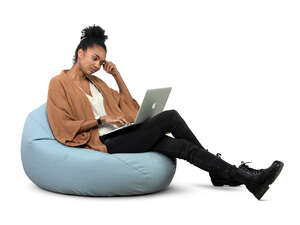 cut out woman sitting on a bean bag and working with laptop