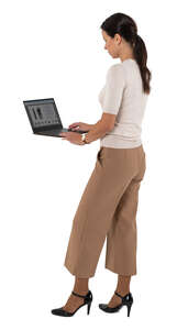 cut out woman standing and working with a laptop at a higher table