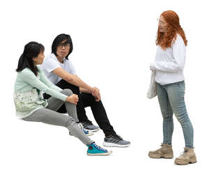 cut out woman standing and talking to two friends sitting on the stairs