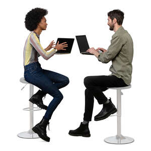 two cut out people with laptops sitting at a counter height table