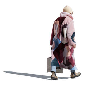 cut out backlit older woman in pink overcoat walking