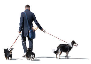 cut out man with three dogs walking